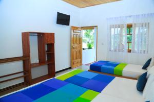 Voodi või voodid majutusasutuse Shan Guest and Restaurant Nilaveli toas