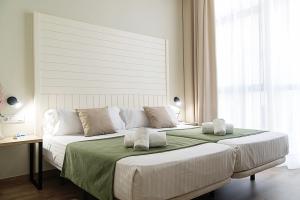
Een bed of bedden in een kamer bij DWO Valencia
