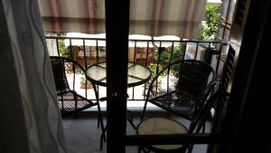 een balkon met een tafel en stoelen op een veranda bij Kadmos in Loutra Edipsou