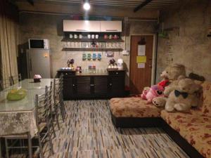 two teddy bears sitting on a bed in a kitchen at goodluck resort@phayao in Phayao