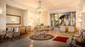 a living room with a table and chairs at Hotel Bellevue - Liburnia in Opatija