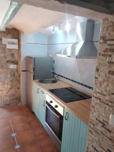 a kitchen with a sink and a stove top oven at La Vía Verde in Jérica