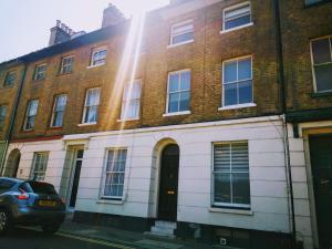 a brick building with a car parked in front of it at Dover Town Rooms - Short Lets & Serviced Accommodation - Dover in Dover