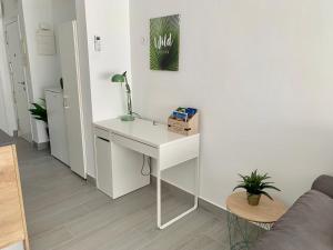 a white desk with a lamp on a white wall at Apartamento Dreamplace in Finestrat +18 photos