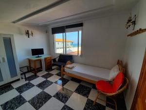 a room with a couch and a chair and a window at House Mare Nostrum in Moncófar
