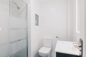 a white bathroom with a toilet and a shower at Aiara apartment by People Rentals in Bilbao