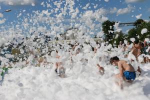 a group of people are playing in a pile of foam at Mini-Hotel Morskoi rif in Golubitskaya
