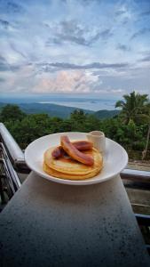a plate of pancakes and hot dogs on a table at The NEST, Tagaytay in Tagaytay