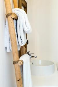 a towel rack in a bathroom with white towels at San Michele in Procida