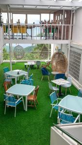 a patio with tables and chairs on the grass at The NEST, Tagaytay in Tagaytay