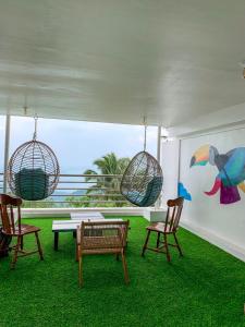 a room with two chairs and a table and two swings at The NEST, Tagaytay in Tagaytay