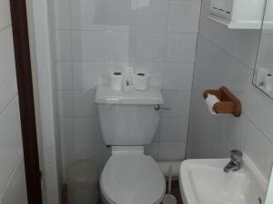 a bathroom with a white toilet and a sink at Belroy Hotel in Blackpool