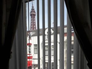 a window with a view of a building and a tower at Belroy Hotel in Blackpool