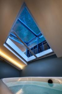a bath tub in a room with a window at Moon and Chalice Boutique Hotel in Kunming