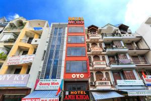 a tall building with a lot of signs on it at ANH KHOA 1 HOTEL Quận 2 in Ho Chi Minh City