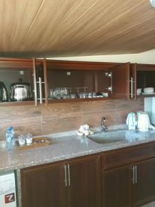 a kitchen with a sink and a counter top at Koura Nahla Apartment in An Nakhlah