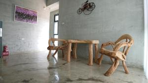 two wooden chairs sitting in a room at Tree House 民宿證號2316 民宿證號2350 in Hualien City