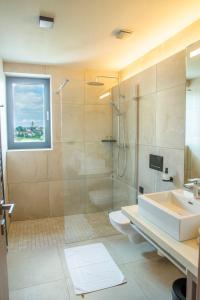 a bathroom with a shower and a sink and a toilet at Hotel AquaCity Seasons in Poprad