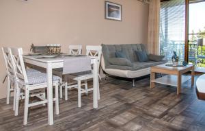 a living room with a table and chairs and a couch at Briz MK Apartment in Ravda