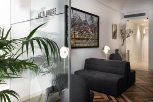 a living room with a black chair and a glass wall at Alta House Begur in Begur
