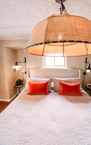 a bedroom with a bed with two orange pillows at The Loft in Granville