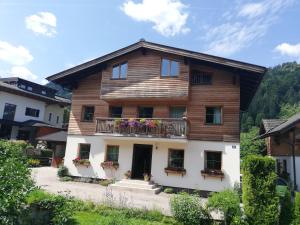 a wooden house with flowers on the balcony at Haus Maria in Kleinarl