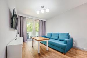 Televízia a/alebo spoločenská miestnosť v ubytovaní Apartamenty Cypel Helski