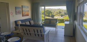 a living room with a couch and a table at Mangrove Beach Estate, Dadda's Place, 321 Bokmakierie WY in Melville