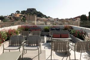 a group of chairs and tables on a patio at Alta House Begur in Begur