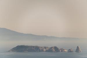 a small island in the water in the fog at Alta House Begur in Begur