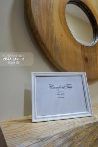 a picture frame sitting on top of a wooden table at Comfort Tua in Mirandela