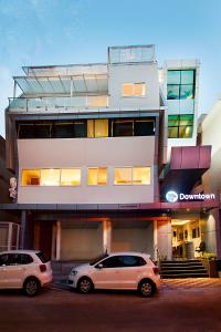 two cars parked in front of a building at Raj Residency in Bangalore