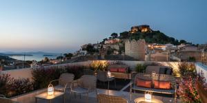 a rooftop patio with chairs and tables and a castle at Alta House Begur in Begur