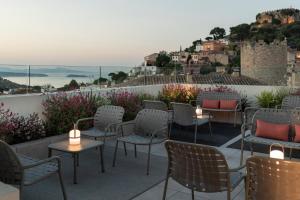 a patio with chairs and tables with a view at Alta House Begur in Begur