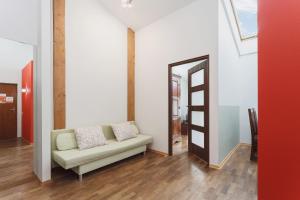 a living room with a couch and a mirror at Apartment Amaretto Długa 60 by Renters in Krakow