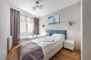 Posteľ alebo postele v izbe v ubytovaní Apartamenty Cypel Helski
