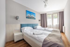 Posteľ alebo postele v izbe v ubytovaní Apartamenty Cypel Helski