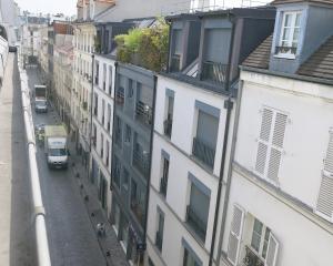 uma vista para uma rua da cidade com edifícios em Studio Bastille Lappe CityCosy em Paris