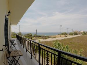 a balcony with benches and a view of the ocean at Alcyon days in Agios Georgios