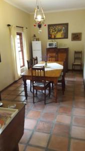 a kitchen and dining room with a table and chairs at MAVILLA STELLENBOSCH B&B in Stellenbosch