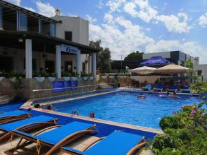 a pool at a hotel with chairs and people in it at Eden Hotel in Bodrum City