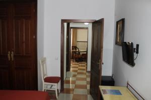 a room with a hallway with a door and a television at Don Paula in Córdoba