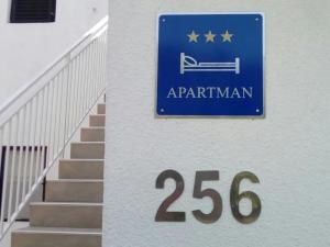 a sign for a apartment with a sign for a stairway at Apartments Kočović in Peroj