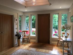 a living room with windows and a table and chairs at Martlets B&B in Shanklin