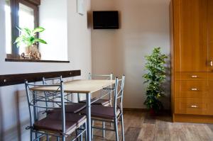 a table and chairs in a room with a plant at Apartamentos Rurales San Xillao in Ribadeo