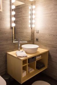 a bathroom with a sink and a mirror at Chalet le Knou in Champéry