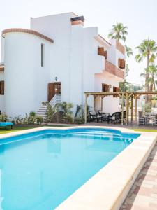 a swimming pool in front of a building at La Colina in Puebla de Vallbona