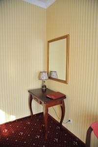 a mirror on the wall of a room at Slava Hotel in Zaporozhye