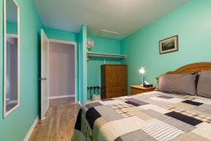 a bedroom with blue walls and a bed at Out East B&B in Norris Point