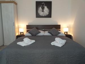 a bedroom with a large bed with two towels on it at Monato in Poprad